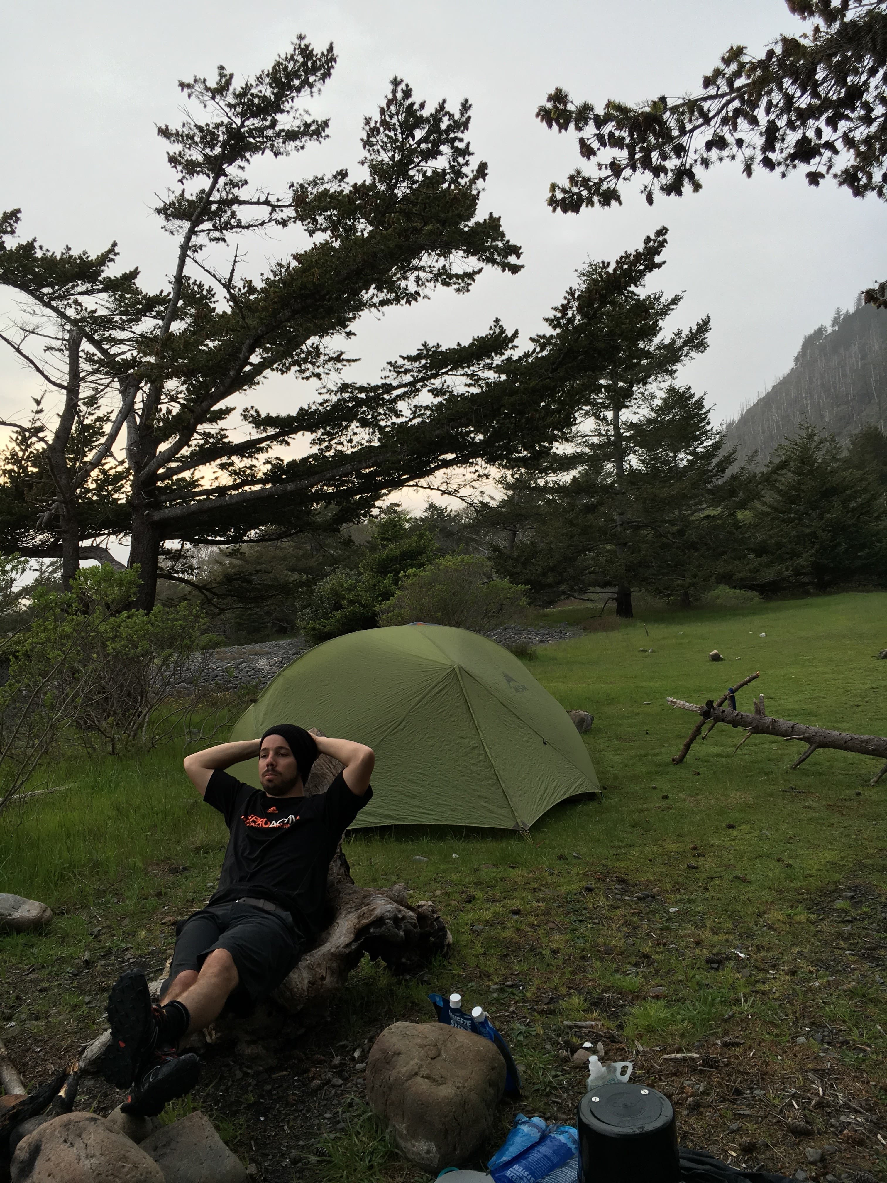 lounging feet up on a log at a campsite