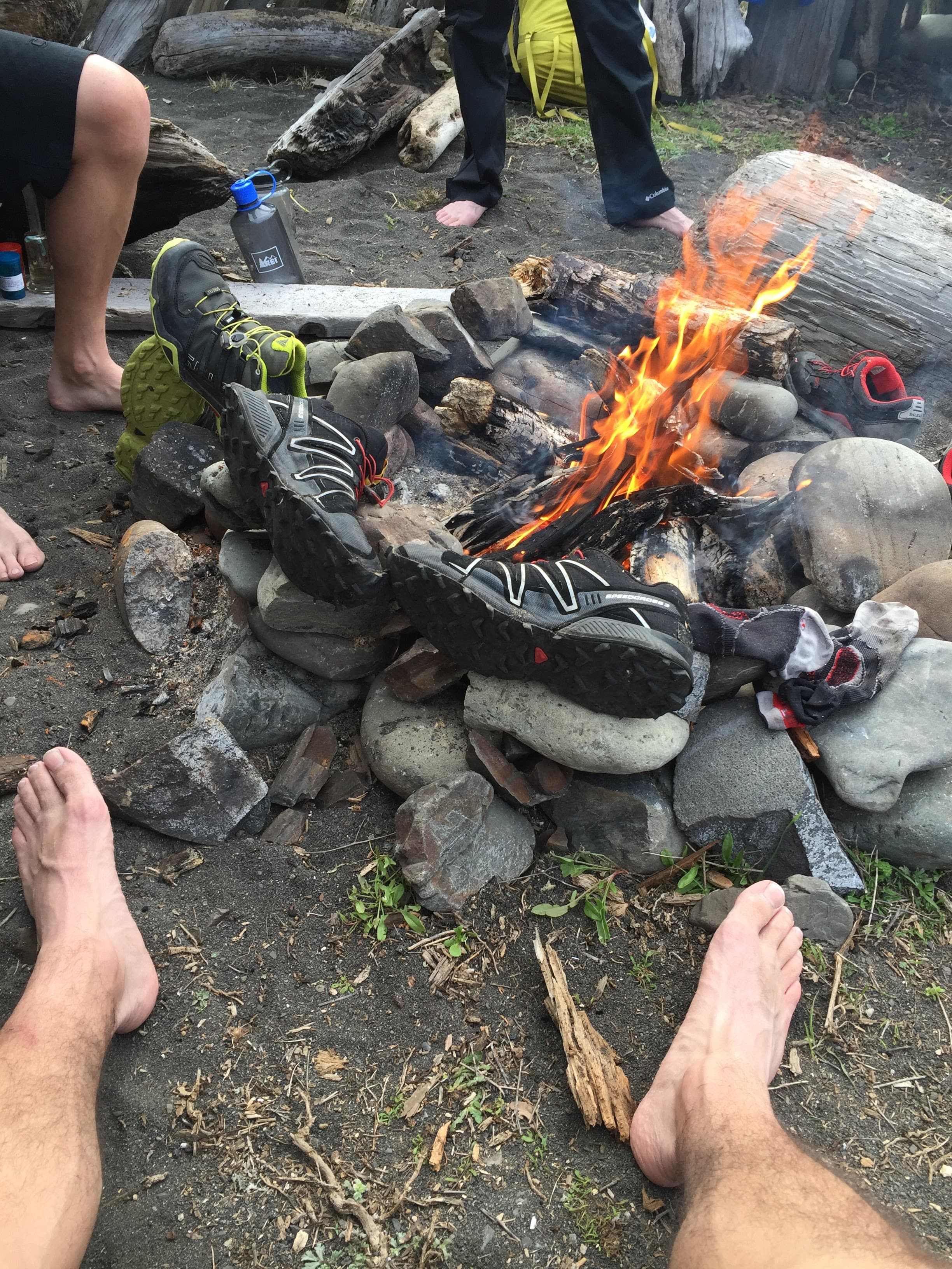 Shoes drying out by a camp fire